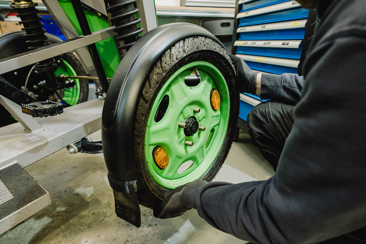 Businessfotografie Unternehmen Unternehmensreportage Mitarbeiter wechselt Rad von einem Cargobike
